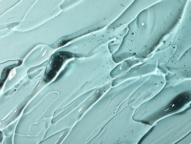 Close-up of light blue gel texture, suggesting a skincare or cosmetic product like serum or moisturizer.